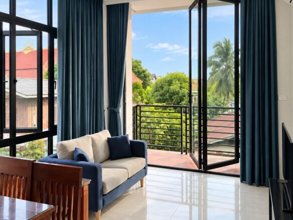 Living room and balcony of the 1-bedroom apartment for rent in Vientiane city center