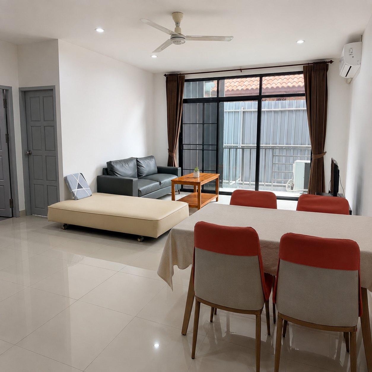 Lounge with sofa and sliding doors onto the balcony in a Vientiane serviced apartment