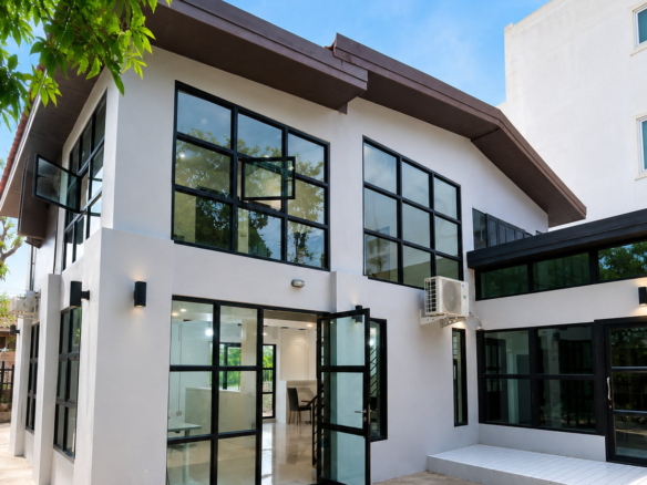 Modern white villa facade with black-framed windows in Sisattanak, Vientiane