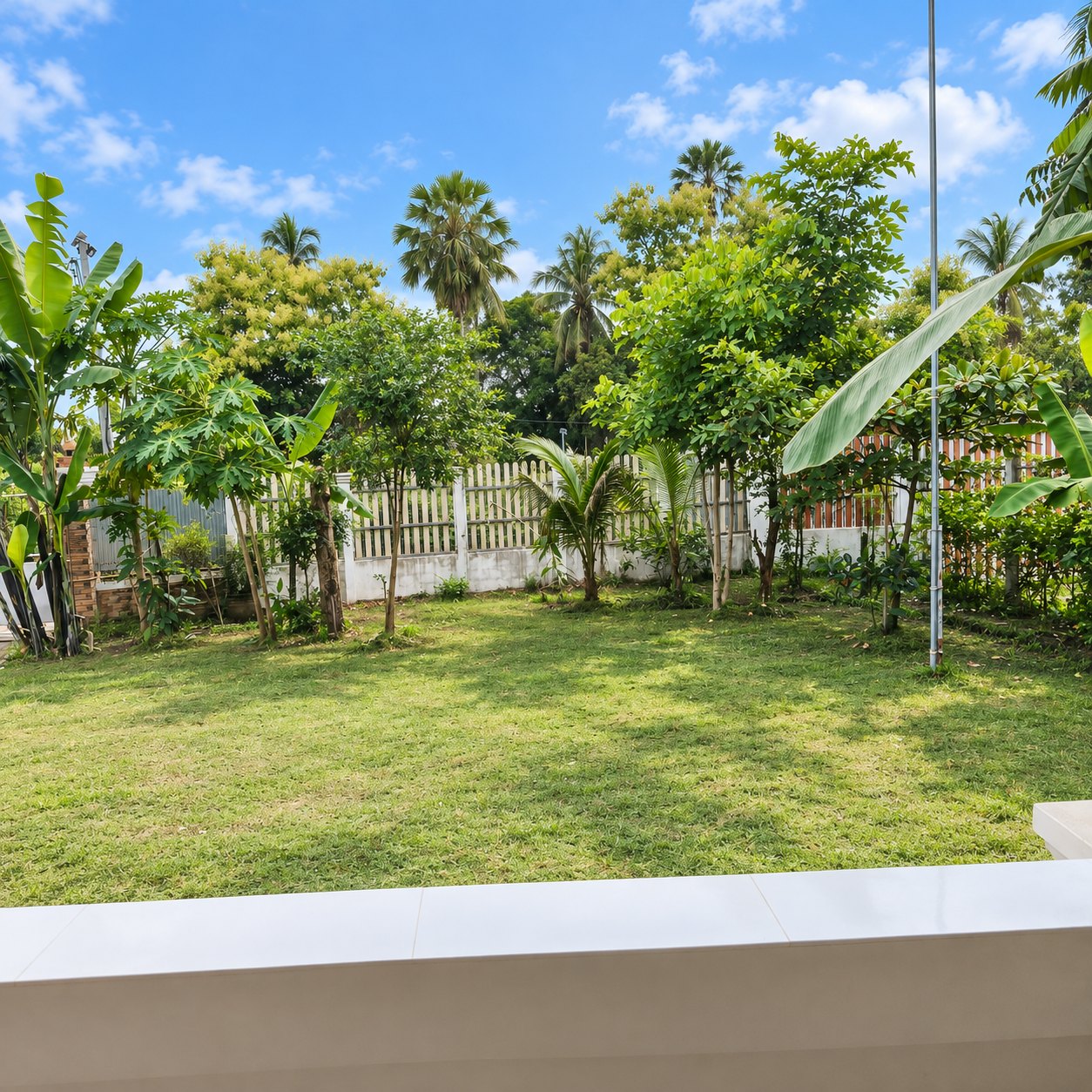 Large fenced garden of the villa for rent in That Luang Lake, Vientiane