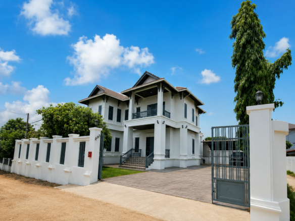 Modern 4-bedroom villa for rent in Vientiane Laos – white facade, gated entrance and private driveway