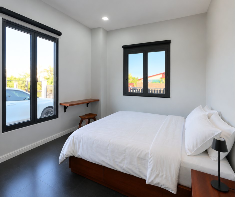 villa khamsavath vientiane guest bedroom Guest bedroom with double bed and twin windows in a Vientiane rental villa