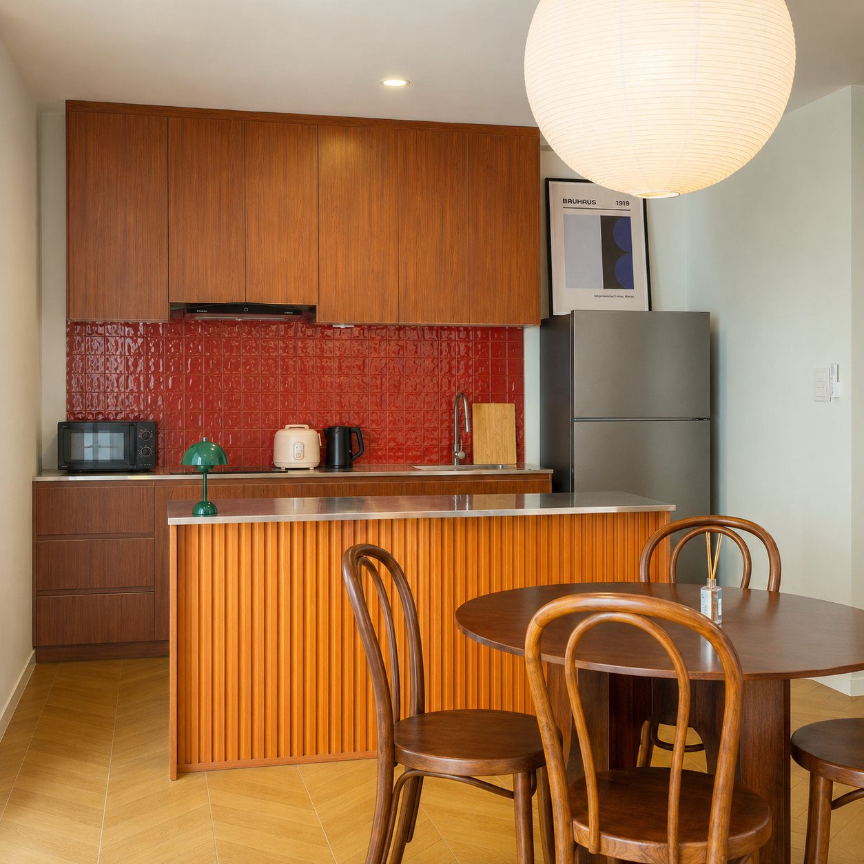 villa sisattanak vientiane kitchen island Kitchen island with red tiled splashback and dining table in a Vientiane villa