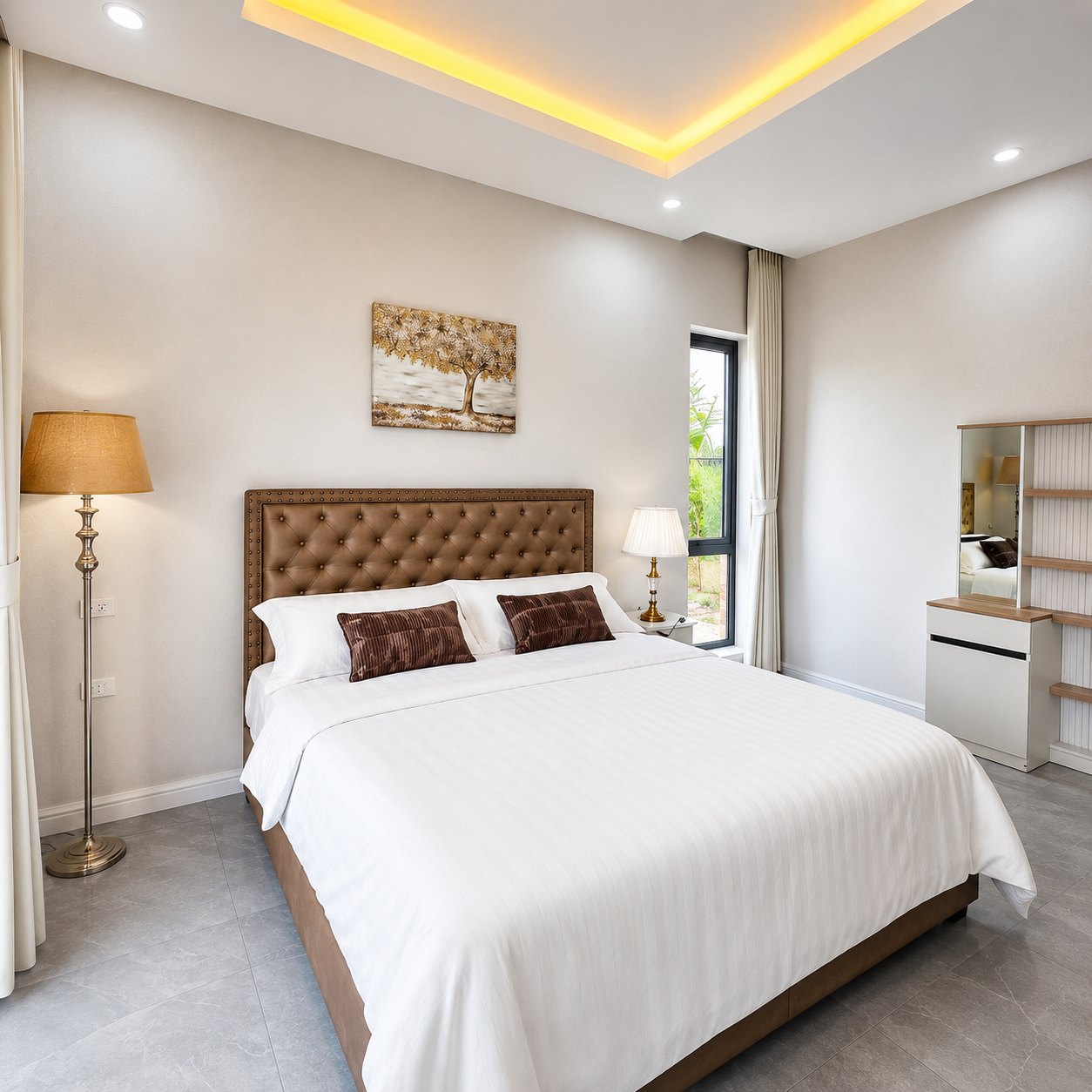 Second bedroom with tufted headboard, dressing unit and garden window in a Vientiane villa
