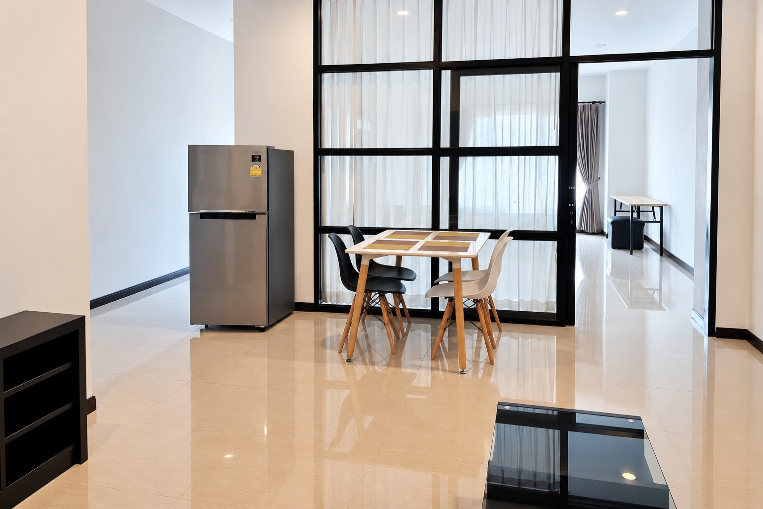 Dining area with fridge and glass partition – 1-bedroom apartment near VIS, Sisattanak, Vientiane