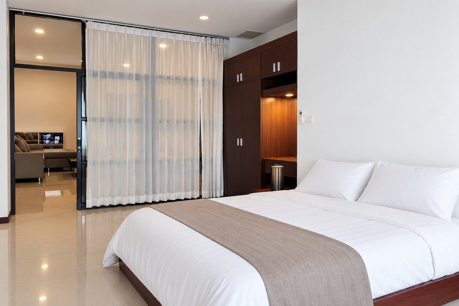 Bedroom with double bed and glass partition to the living room – 1-bedroom apartment near VIS, Sisattanak, Vientiane