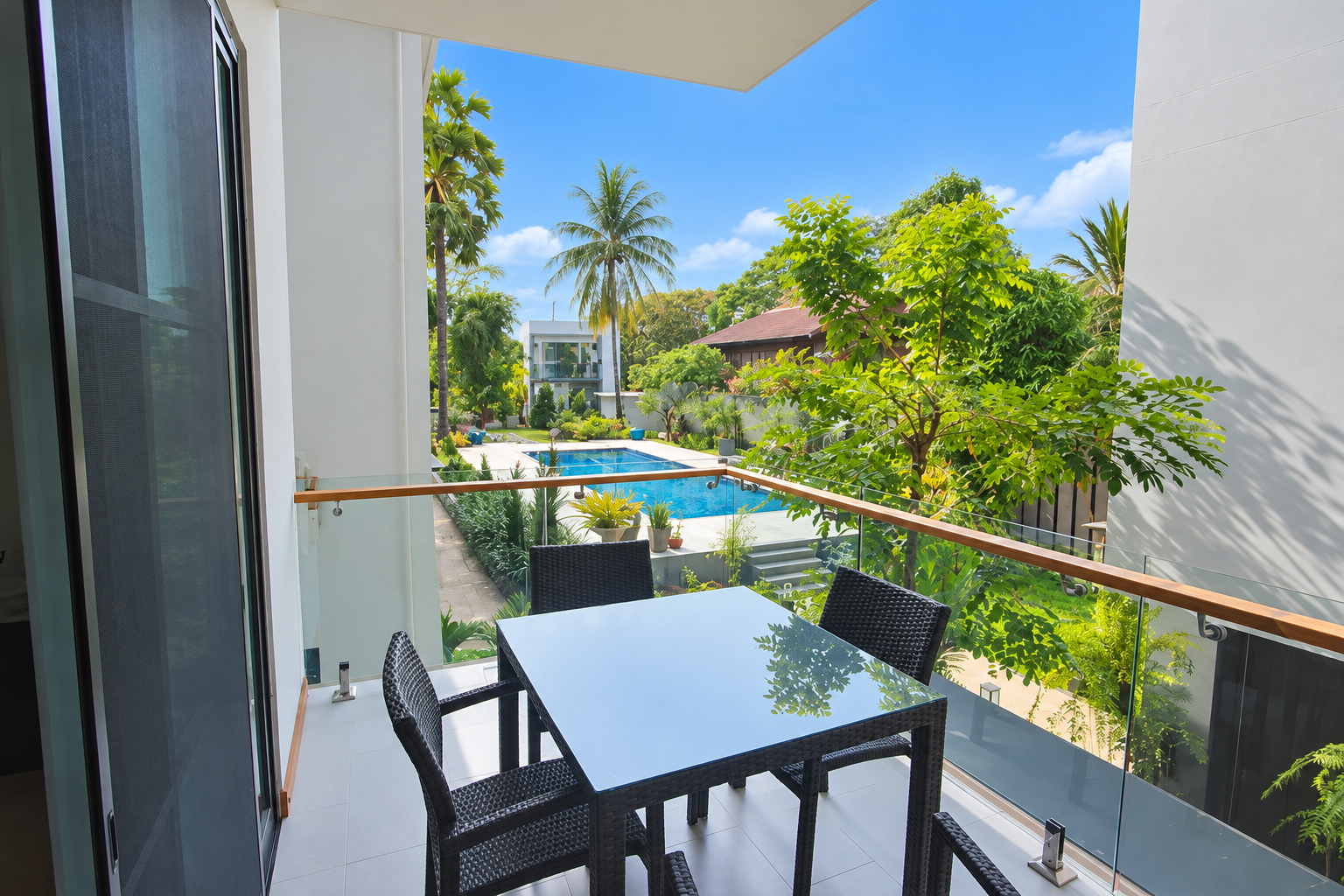 Private balcony with table overlooking the pool – large apartment 2 bedrooms with pool and gym, Sisattanak expat area, Vientiane