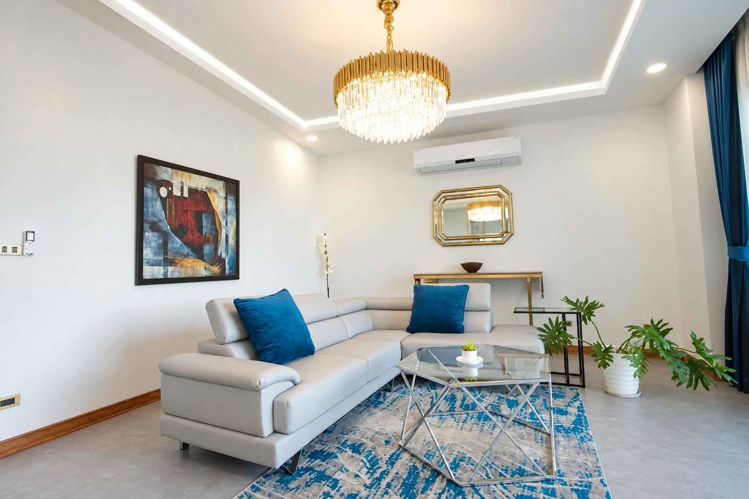 Living room with leather corner sofa and crystal chandelier – large apartment 2 bedrooms with pool and gym, Sisattanak expat area, Vientiane