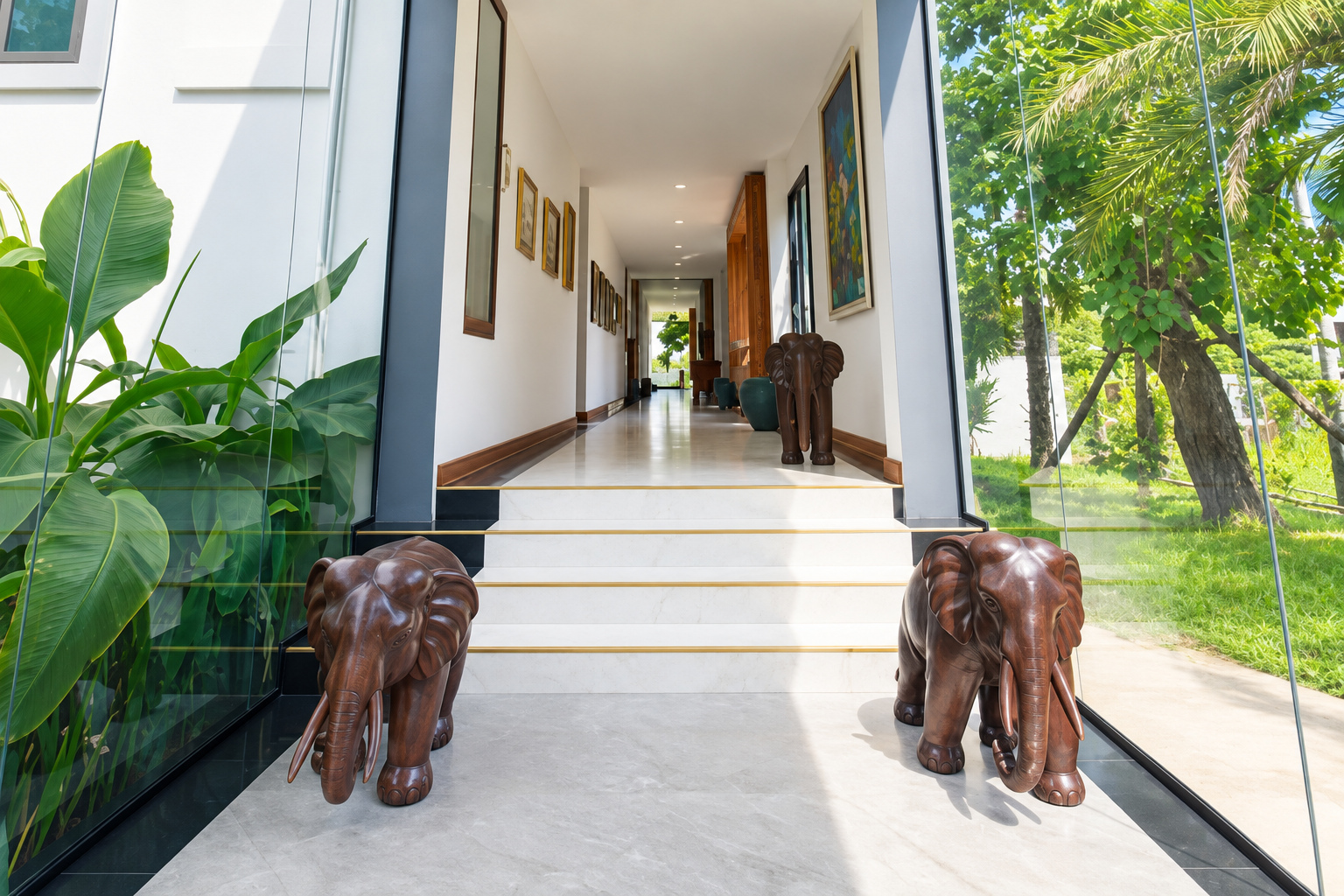 Residence entrance hall with carved wooden elephants – large apartment 2 bedrooms with pool and gym, Sisattanak expat area, Vientiane