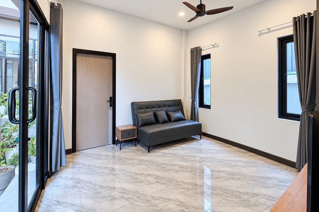 Sitting area with sliding glass door – 1-bedroom apartment Vientiane