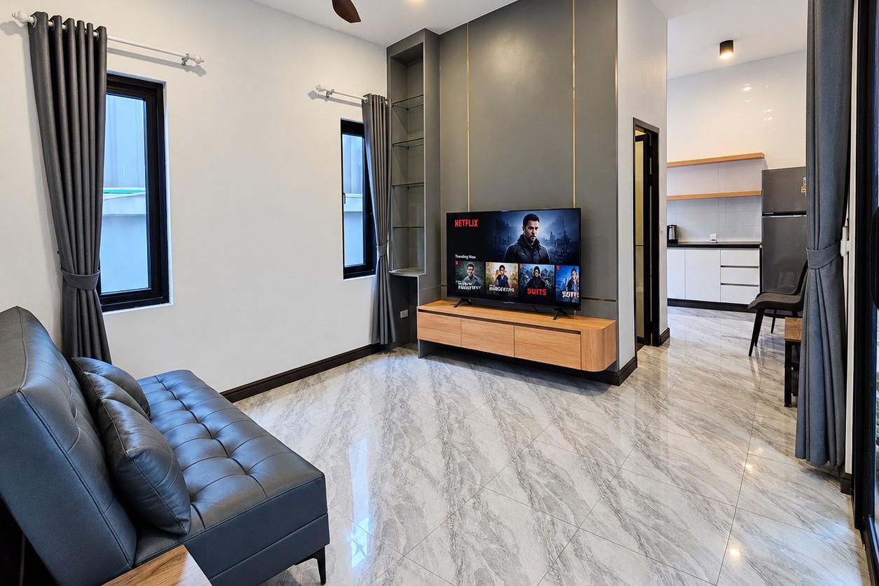 Living room with smart TV and open kitchen – new apartment near Patuxai