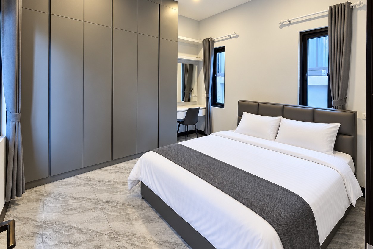 Bedroom with double bed, fitted wardrobe and vanity desk – apartment Vientiane