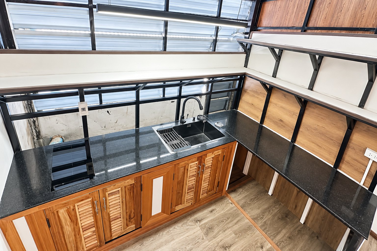 Kitchen with induction hob and black sink – new apartment, city center, Vientiane
