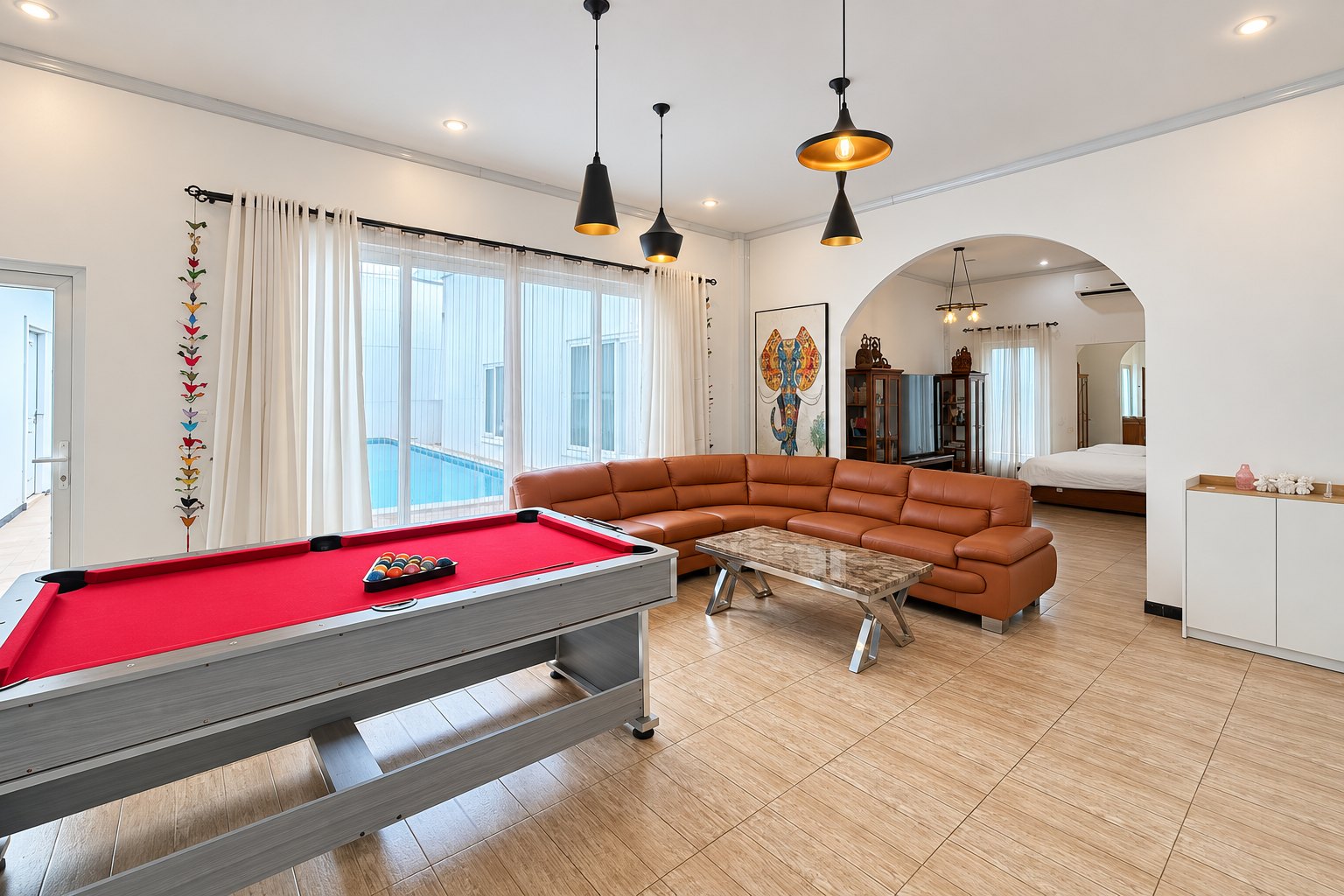 Living room with pool table and arch to bedroom – near Khamsavath railway station, Vientiane