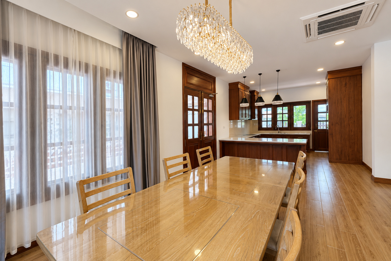 Dining area with crystal chandelier and open kitchen – new villa, Xaysettha, Vientiane